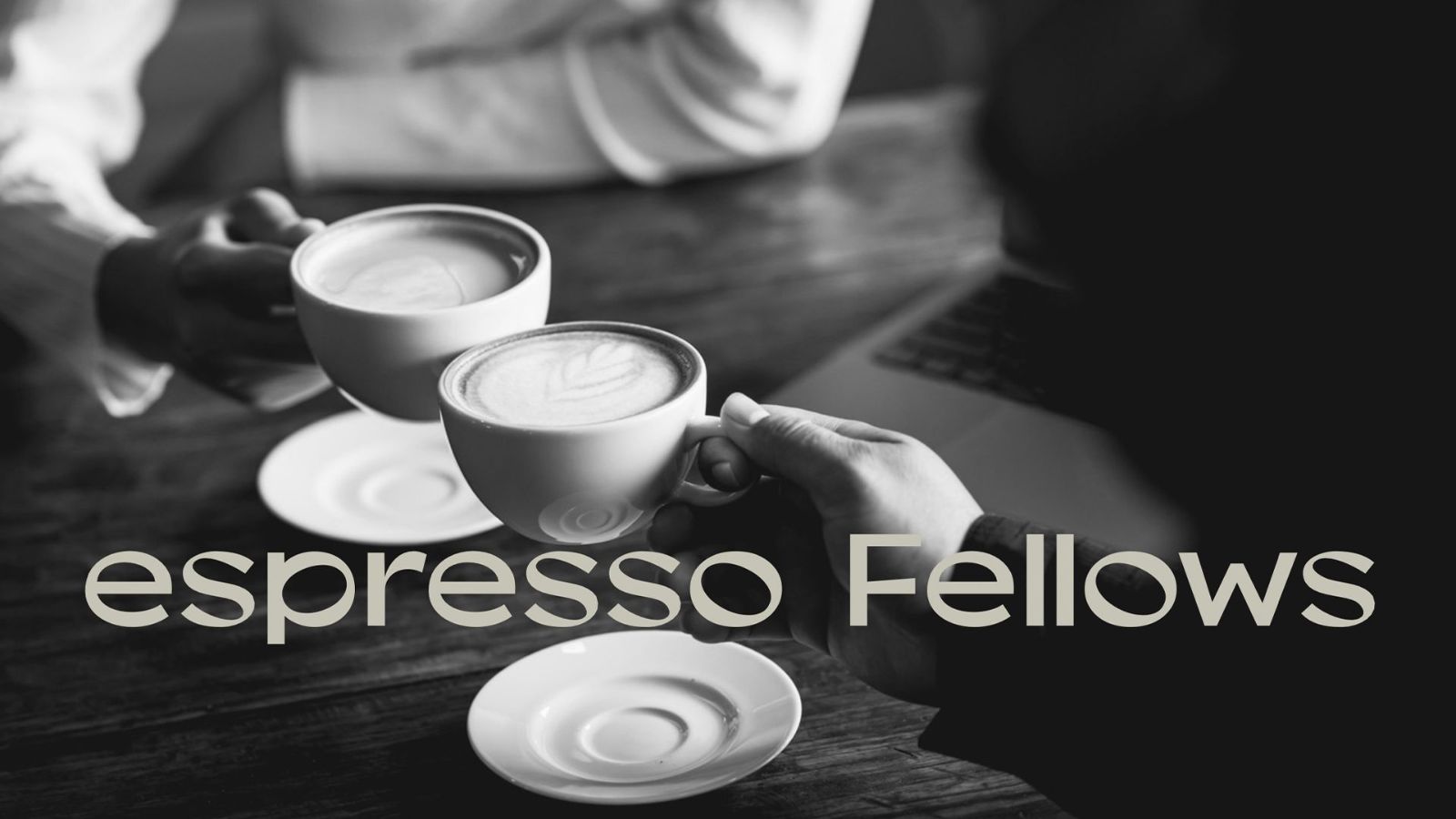 Two cups of latte shared across a table